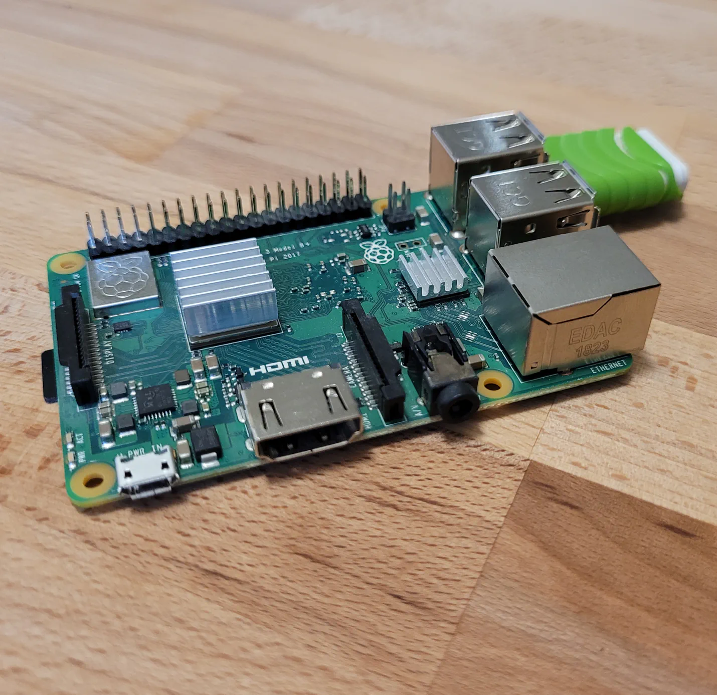 A Raspberry Pi 3+ with a USB flash drive installed into one of the onboard USB ports.