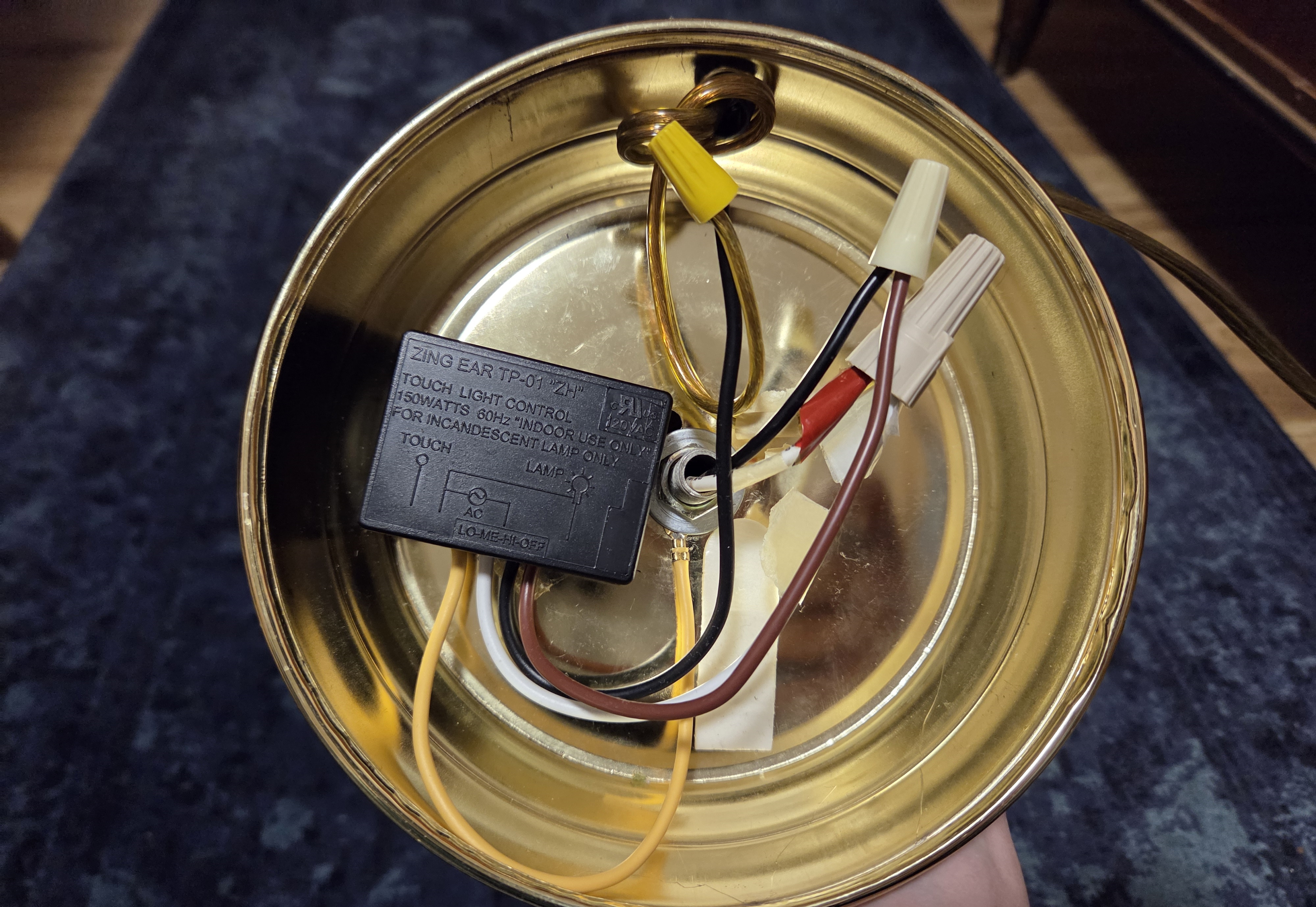 What the insides of the lamp looked like after the repair. The touch switch box is now smaller and instead of beige it is black.